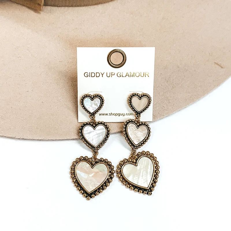 Hoop earrings with braided patterns for a detailed and textured finish-Three Tiered Hearts Ivory Shell Dangle Earrings in Gold